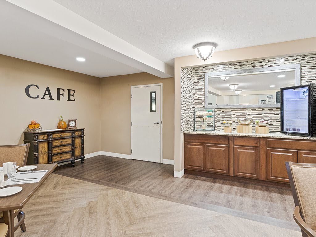 A modern cafe interior with wood flooring and stylish decor.