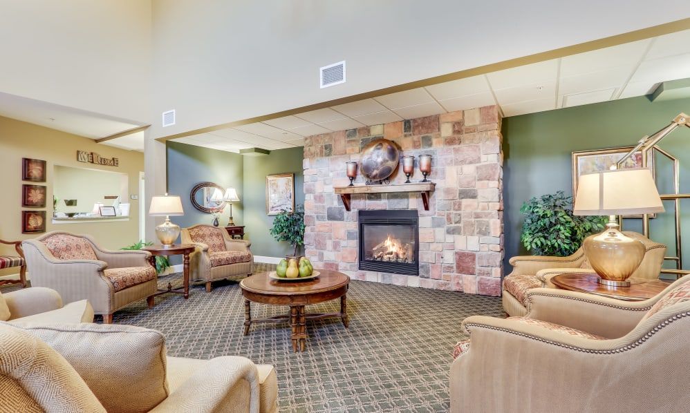A cozy living room featuring a fireplace with comfortable seating and elegant decor.