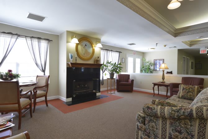 A cozy living room with a fireplace and comfortable seating.