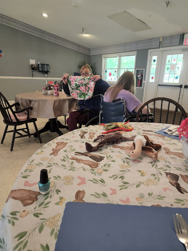 A cozy family gathering with children playing dolls at a table.