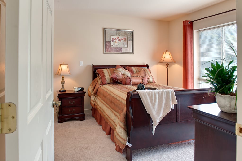 A cozy bedroom with warm colors and elegant furnishings.