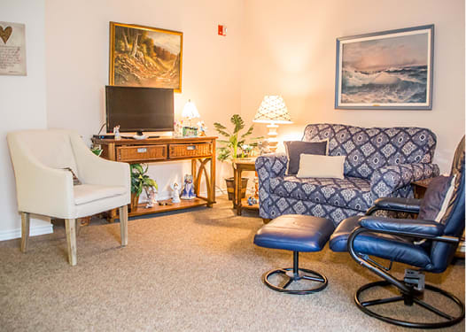 A cozy living room with comfortable furniture, a television, and tasteful decor.