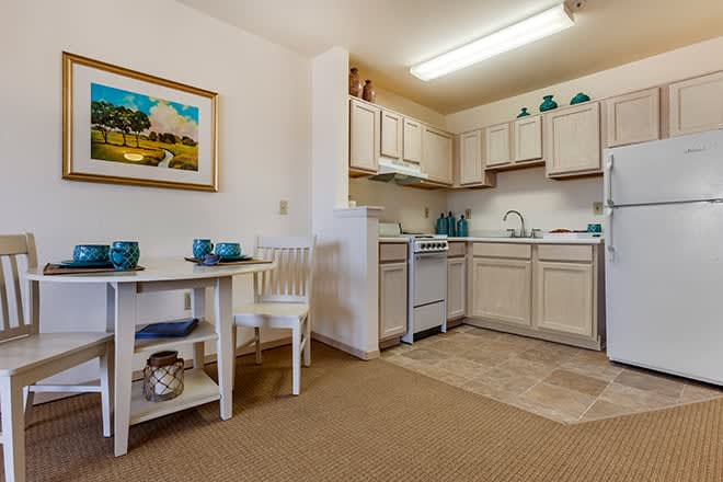 A cozy apartment kitchen with a small dining area.