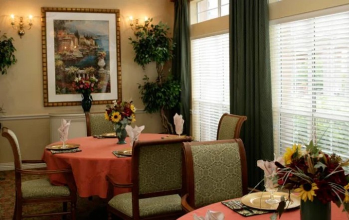 A cozy dining room with elegantly set tables and warm decor.