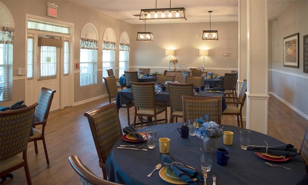 A well-decorated dining room with elegantly set tables and comfortable chairs.