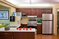 A modern kitchen with stainless steel appliances and wooden cabinets.