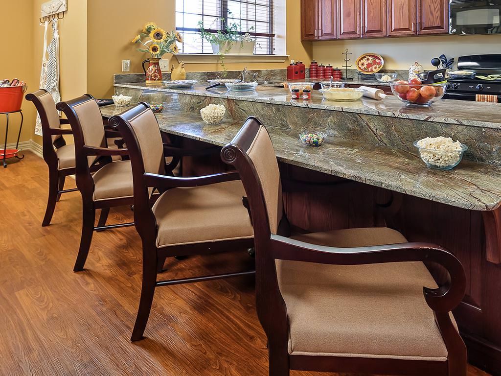 A cozy kitchen with a marble countertop and elegant chairs, perfect for dining and entertaining.