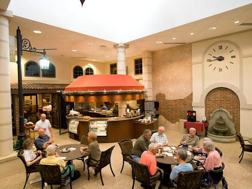 A cozy dining area filled with senior citizens enjoying a meal together.