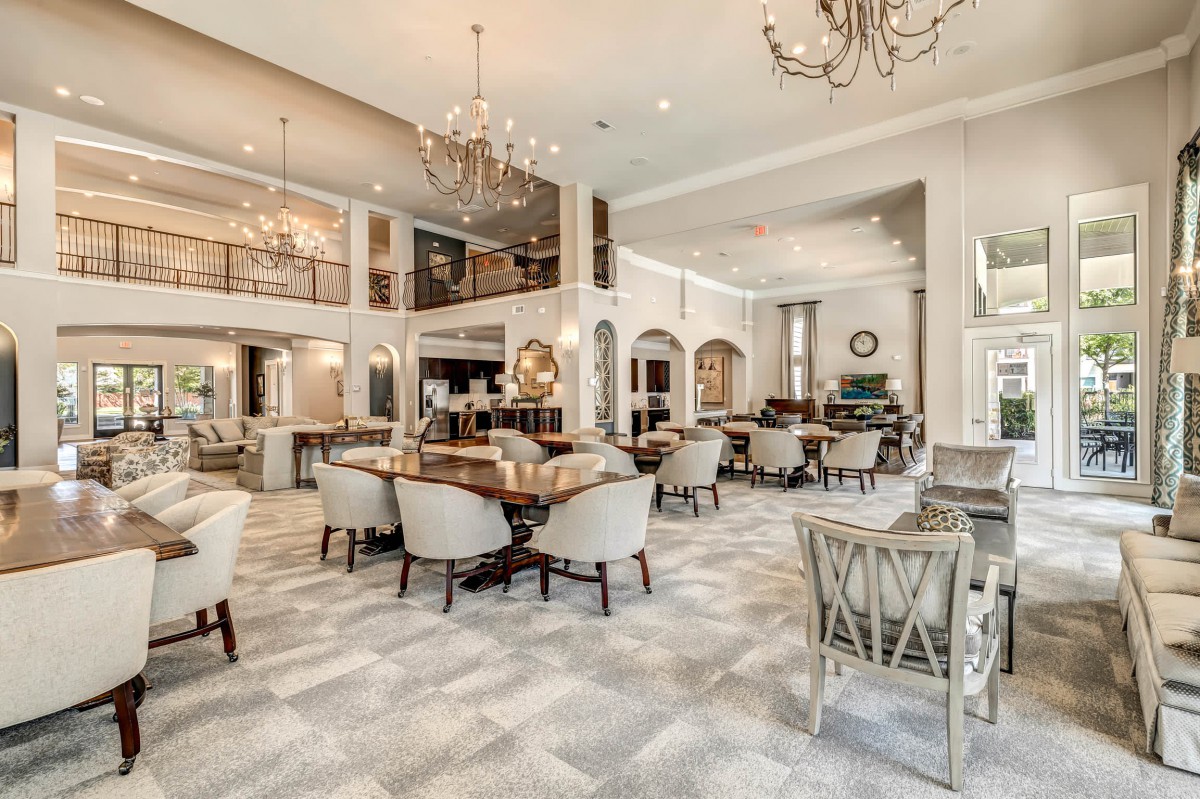 A luxurious and spacious dining area adorned with elegant chandeliers and comfortable seating.