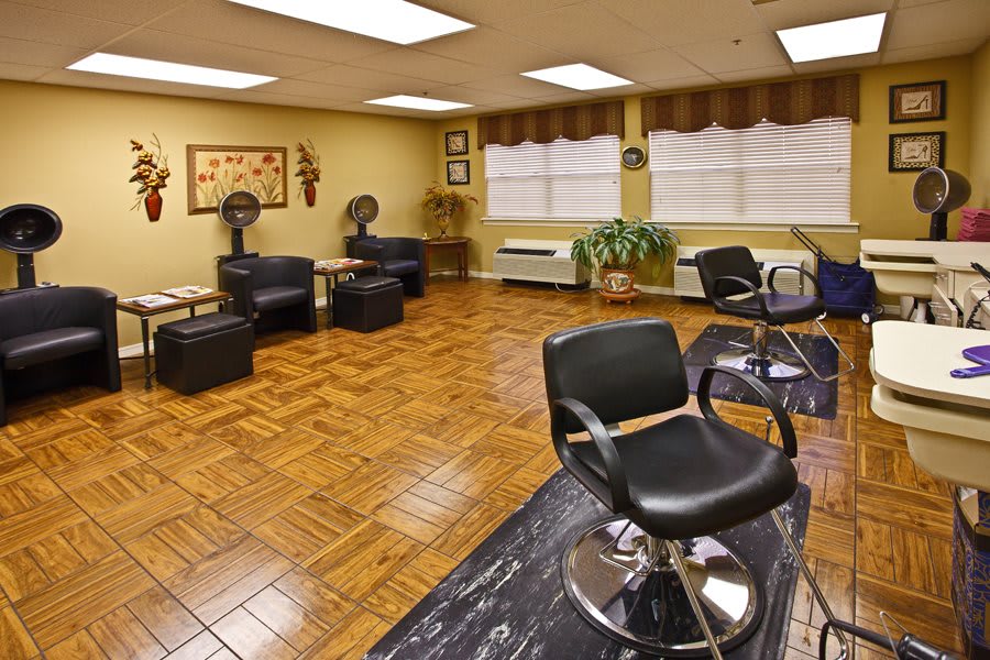 An empty hair salon with chairs and a waiting area.