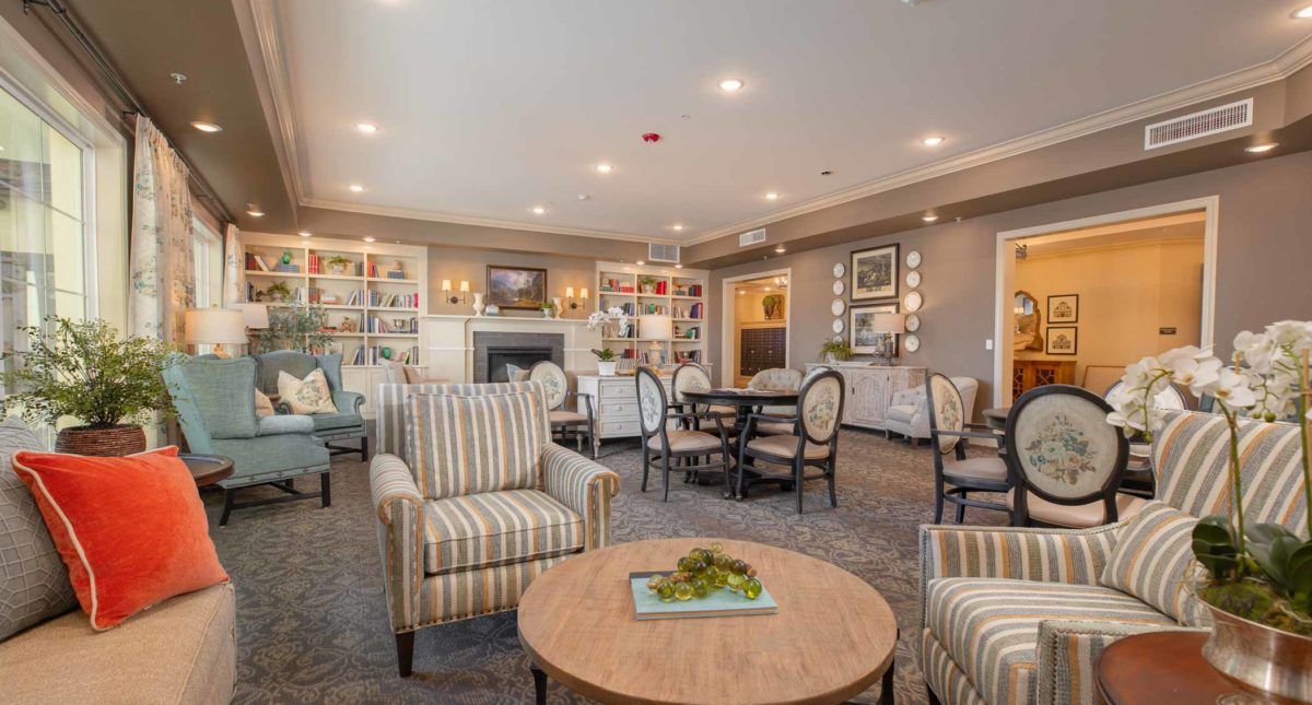 A cozy living room with comfortable seating, a fireplace, and elegant decor.