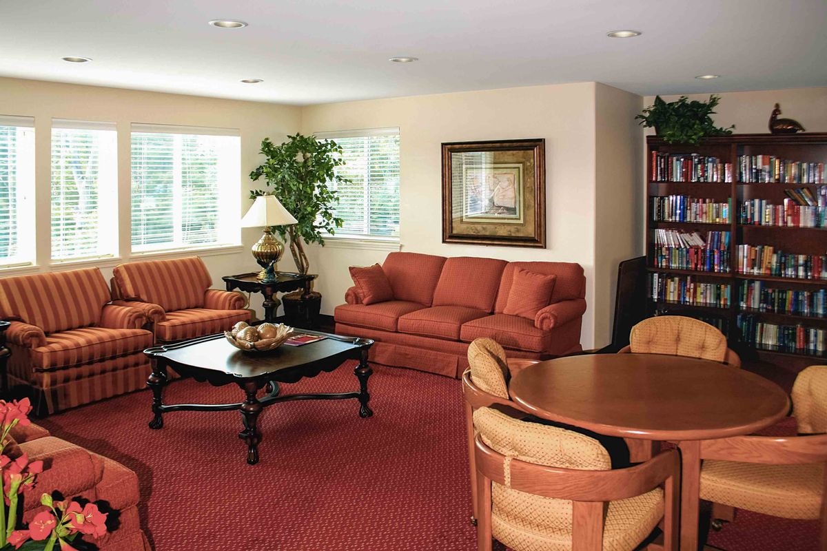 A cozy living room with comfortable sofas, a coffee table, and warm decor.