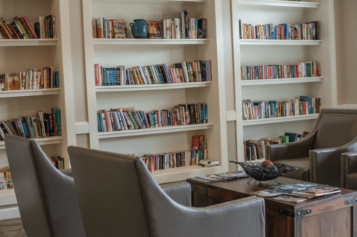 A cozy reading area with bookshelves and comfortable chairs.