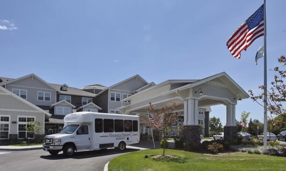 A view of a large building with a shuttle bus parked near the entrance.