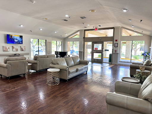 A spacious and welcoming lounge area featuring modern furniture and ample natural light.