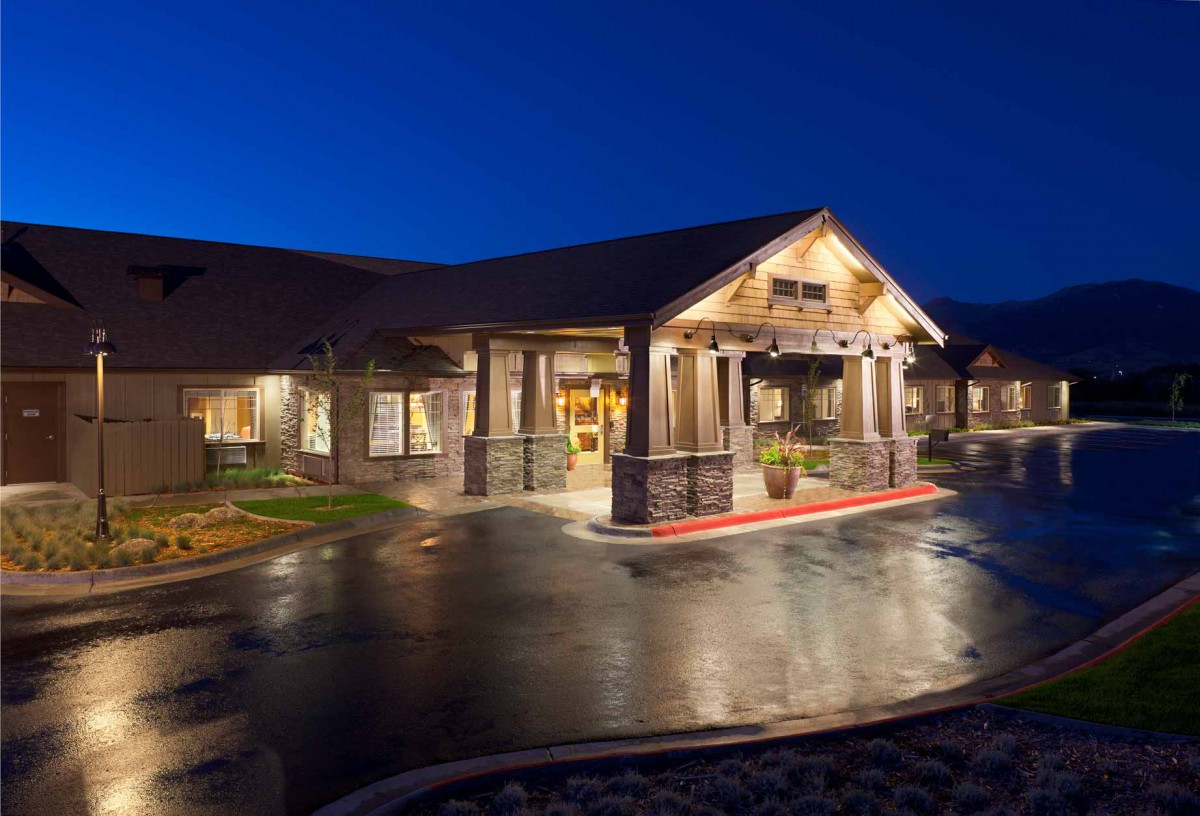 A warmly lit building at night with an inviting entrance.