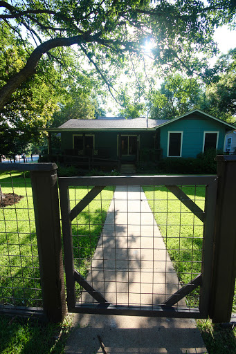 A charming house surrounded by greenery and a welcoming pathway.