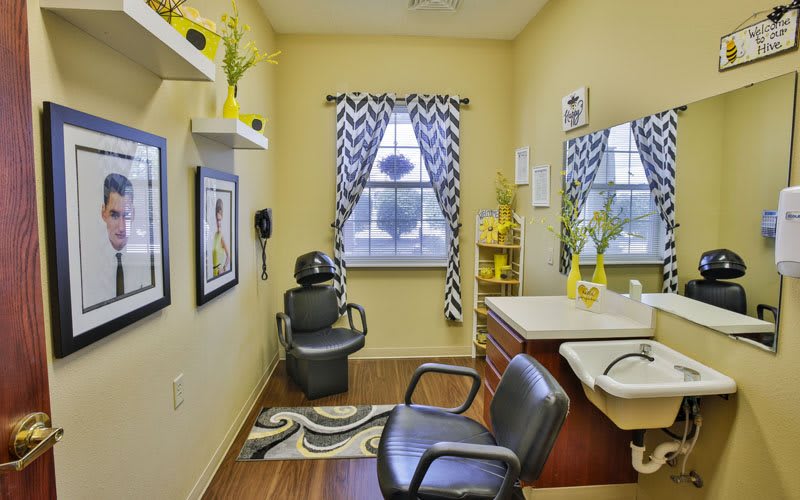 A modern hair salon with stylish chevron curtains and yellow accents.