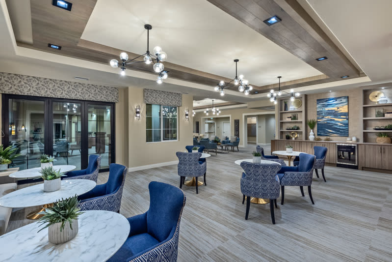 A modern lounge area with elegant seating and chandeliers.