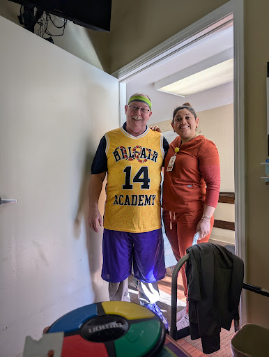 A cheerful moment shared between two friends, one in a basketball jersey.
