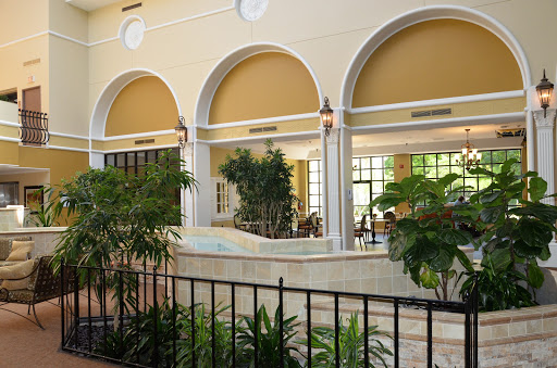 A beautifully designed indoor space featuring arched windows and lush greenery.