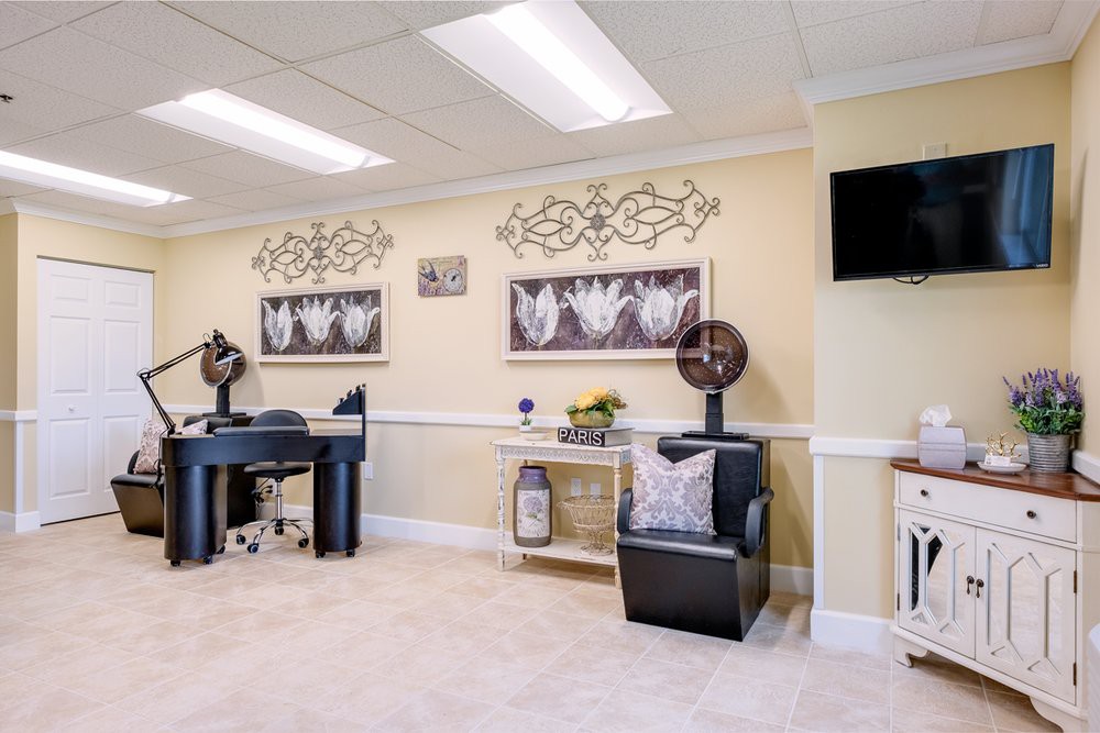 A well-decorated salon interior with stylish chairs and wall art.
