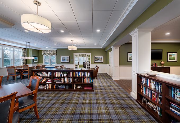 A well-lit library interior with bookshelves and seating areas.