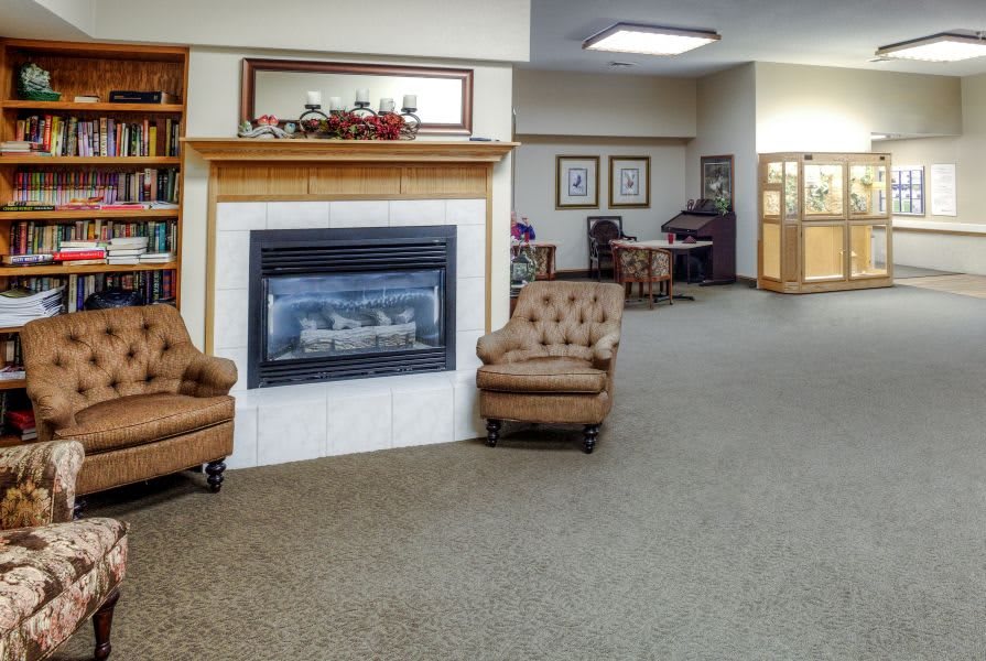 A cozy lobby area featuring a fireplace and comfortable armchairs.