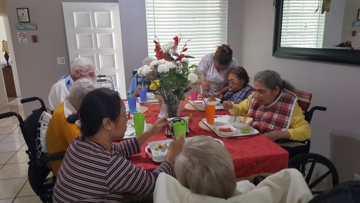 A warm family gathering around the dining table, enjoying a meal together.