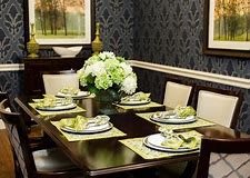 An elegantly set dining table with floral centerpiece and coordinated decor.