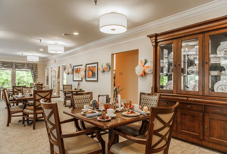 A cozy dining room with elegantly set tables and warm decor.