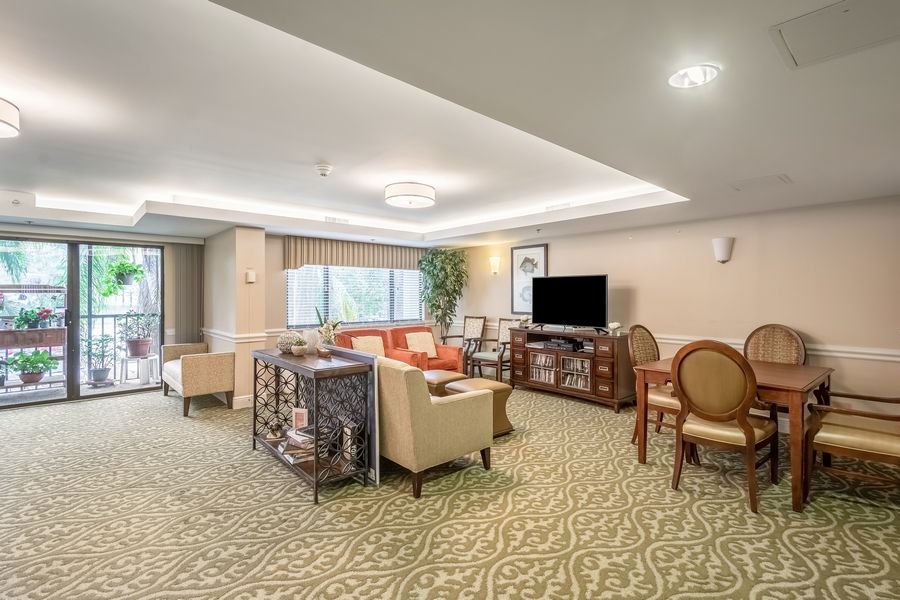 A spacious living room with elegant furnishings and a dining area.