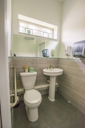 A modern and clean bathroom featuring a toilet and sink.