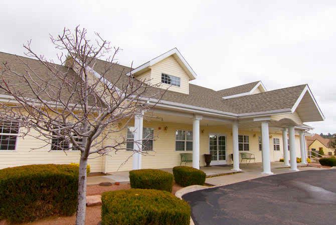 A suburban residential building with a well-maintained exterior and landscaped front.