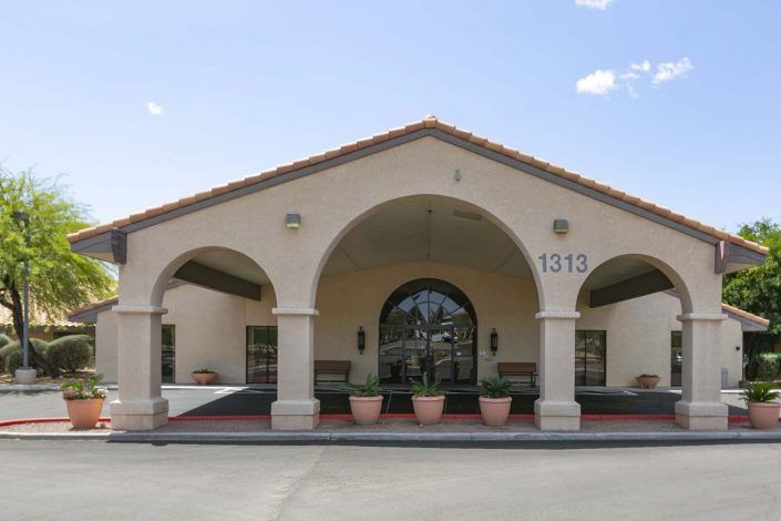 A building with arched entrances and a tiled roof.