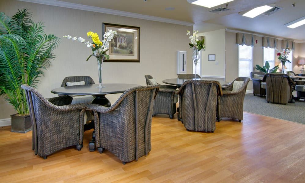 A well-arranged dining area with tables, chairs, and floral decorations.