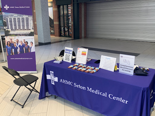 Information booth for ASMC Salin Medical Center showcasing healthcare services and resources.