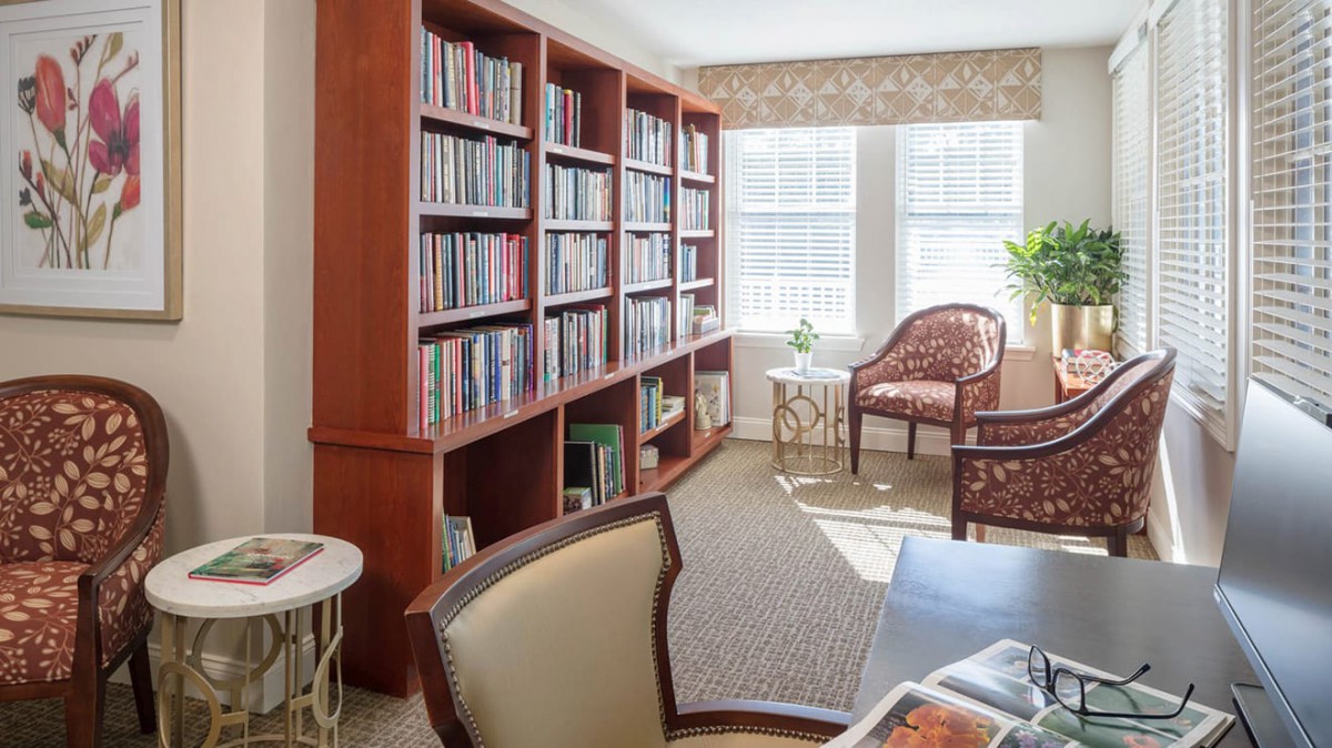 A cozy reading room with bookshelves and natural light.