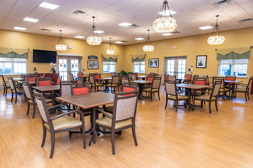 A spacious dining room with wooden tables and chairs, designed for comfort and social gatherings.