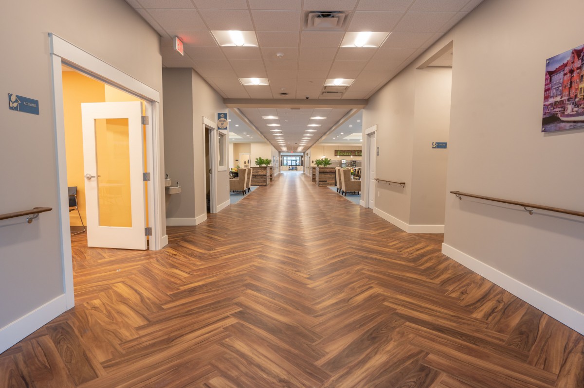 A modern hallway with wooden flooring and soft lighting.