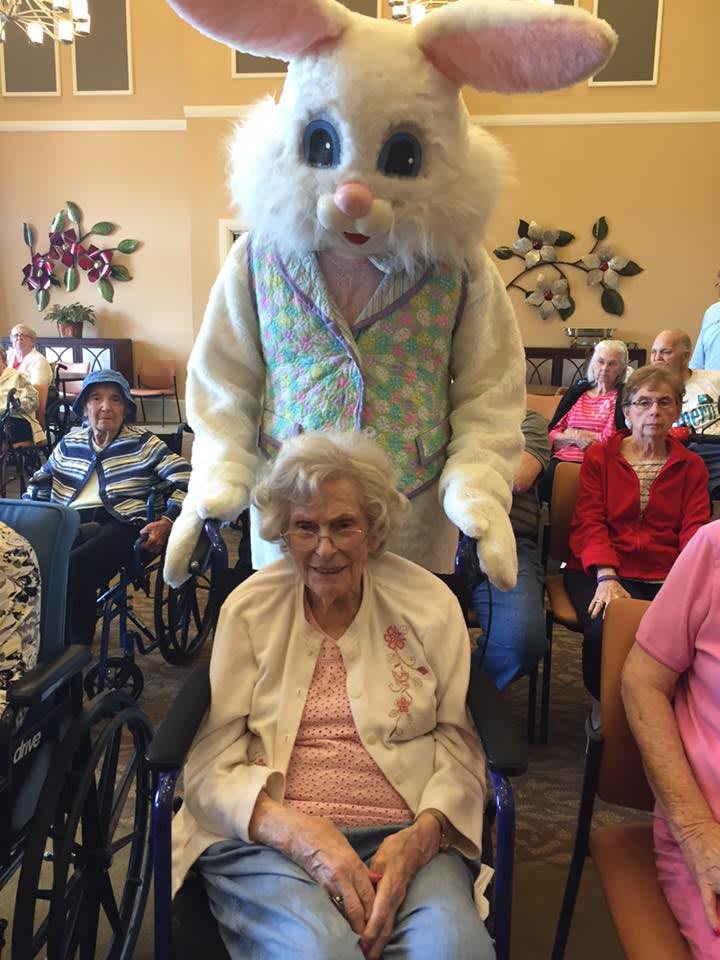 A festive gathering at a nursing home with an Easter bunny and residents.