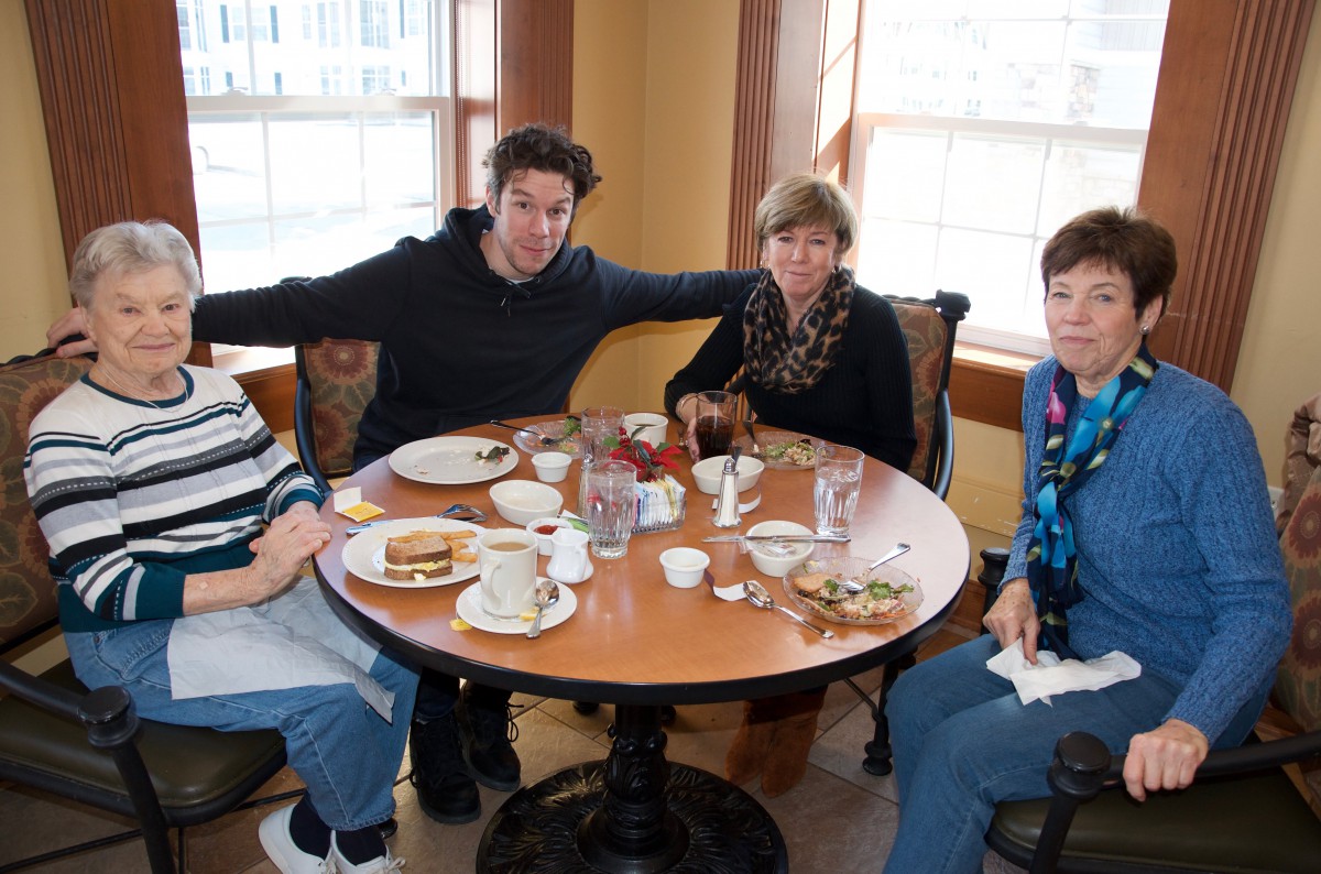 A group of people enjoying a meal together at a restaurant table.