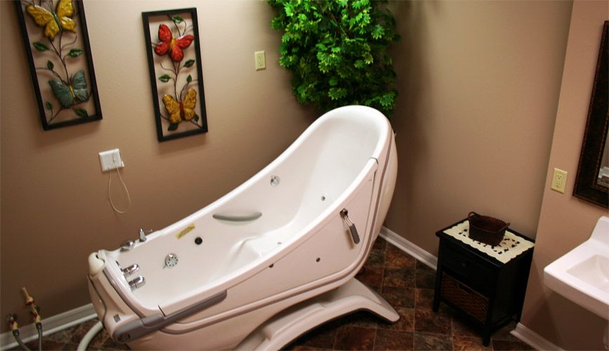 A modern spa bathtub in a warmly decorated bathroom.