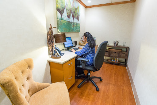 A woman working at her desk in a modern office environment.
