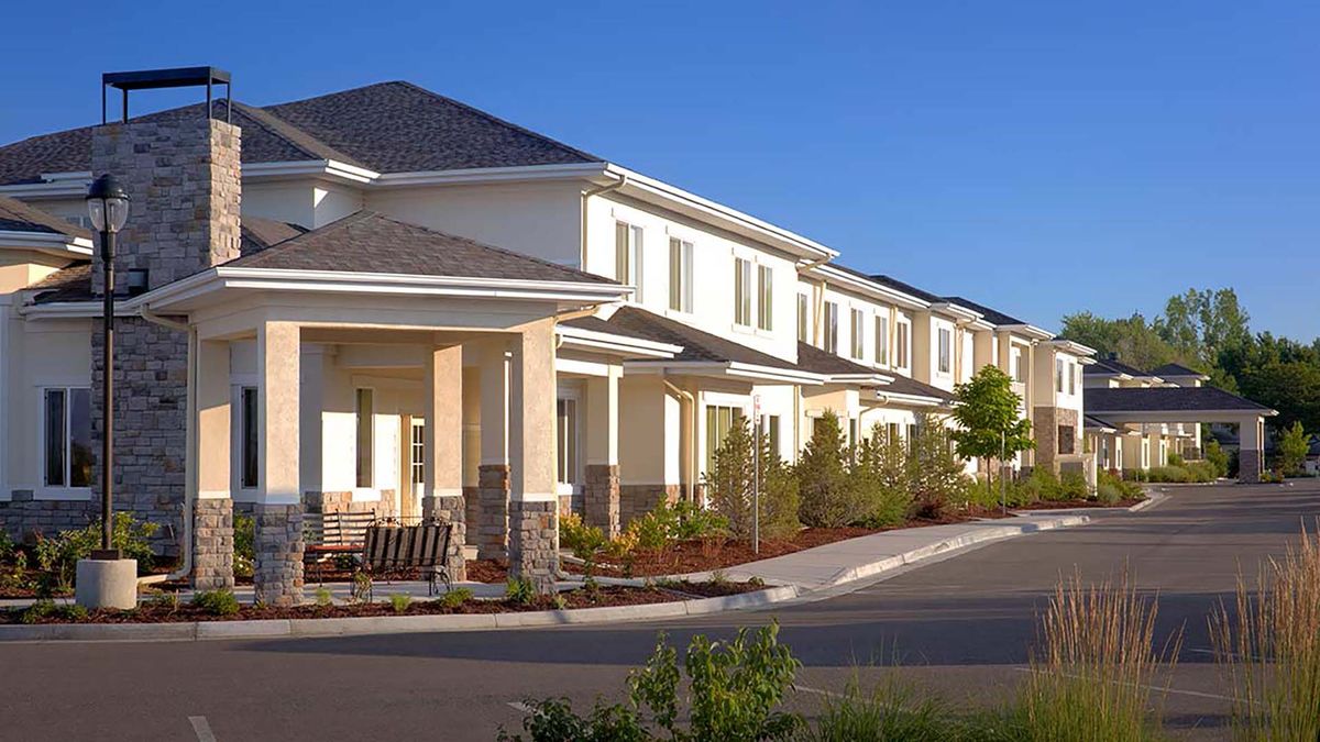 A row of modern townhouses in a suburban residential area.
