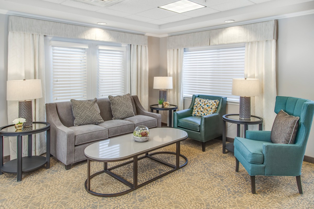 A cozy living room with a sofa, armchairs, and a coffee table.