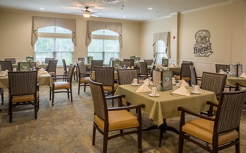 A neatly arranged dining room with tables and chairs ready for guests.