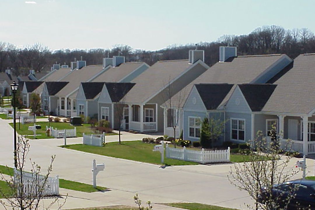 A row of similar-looking houses in a suburban neighborhood.