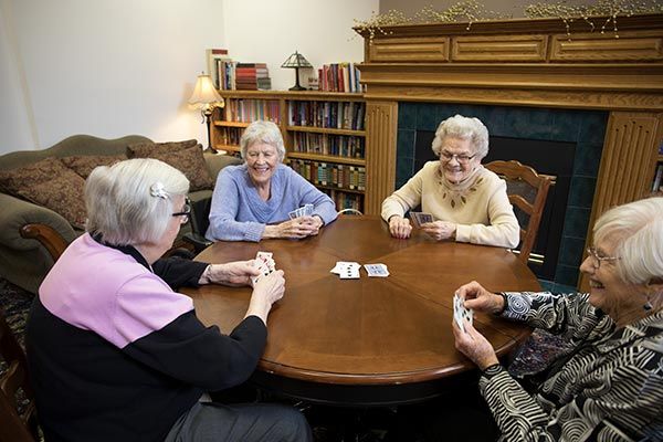 A group of seniors enjoying a card game together in a cozy room.