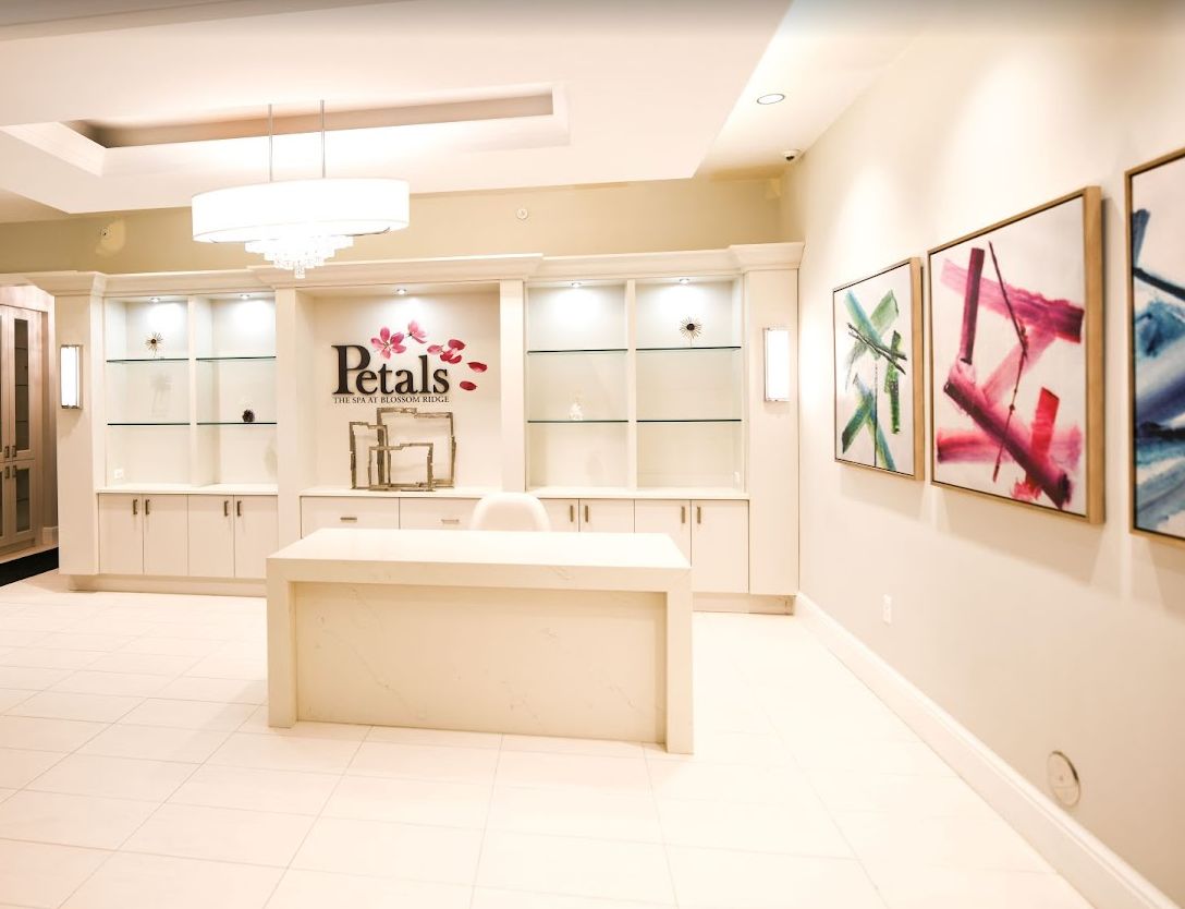 A modern store interior with display shelves and colorful artwork on the walls.